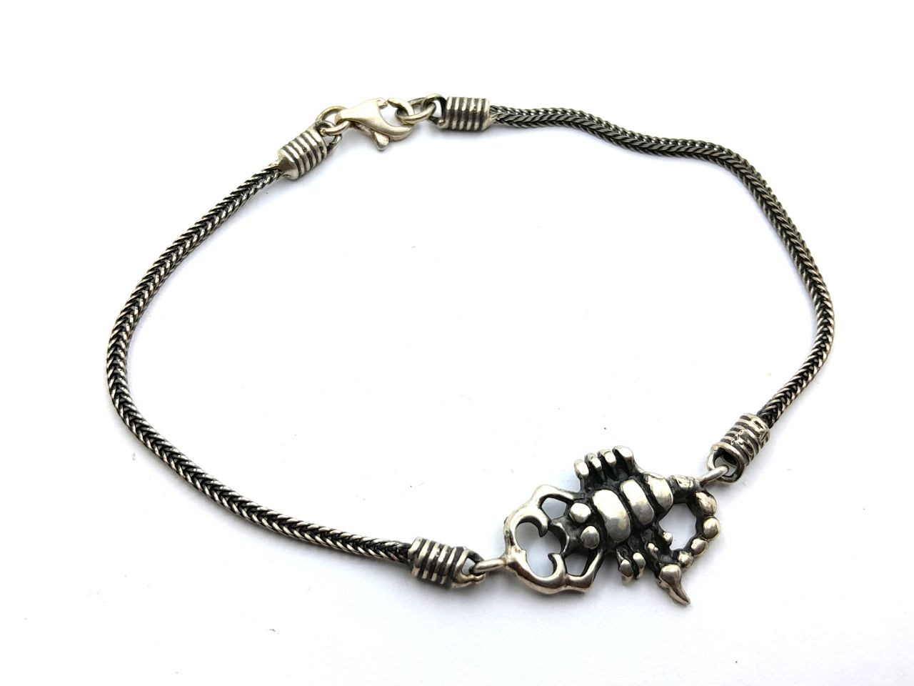 Silver bracelet in the shape of a scorpionاسورة 